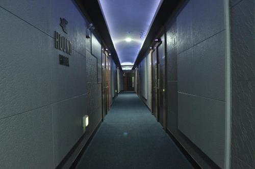 an empty hallway in a gym with a purple ceiling at HOUND Hotel Sangmu in Gwangju