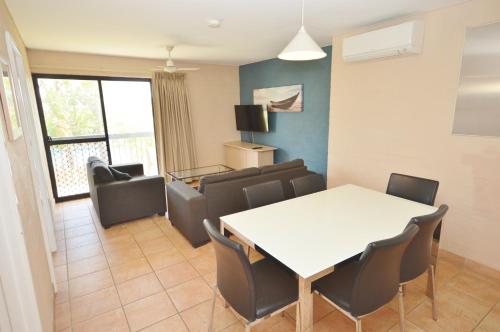 a living room with a white table and chairs at Riverview Holiday Apartment 65 - Kalbarri WA in Kalbarri