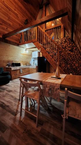 a wooden table in a room with a staircase at Tiny A Frame in Ciutura