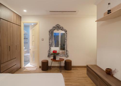 a bedroom with a bed and a mirror on the wall at Aaron Boutique Hotel in Nha Trang