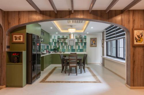 an archway in a kitchen with a table and chairs at Aaron Boutique Hotel in Nha Trang
