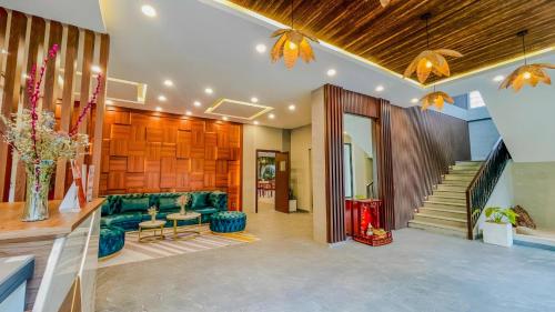 a living room with a green couch and a staircase at The Luxury in Siem Reap