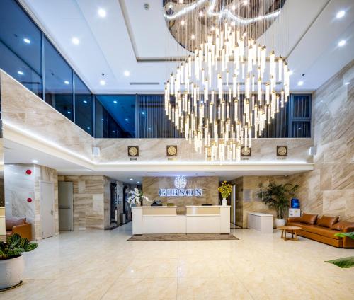 a lobby with a large chandelier in a hotel at Gibson Hotel Nha Trang in Nha Trang