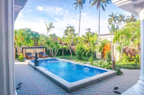 a swimming pool in the backyard of a house at Abian nyuh lovina in Lovina
