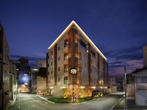 a large building with a clock on the side of it at Y-HOTEL - Vacation STAY 22330v in Hiroshima