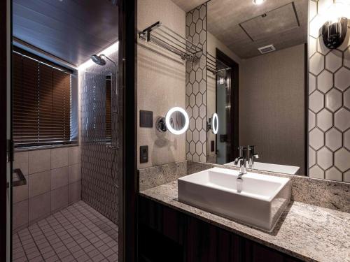 a bathroom with a sink and a shower at Y-HOTEL - Vacation STAY 22330v in Hiroshima