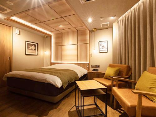 1 dormitorio con 1 cama grande y 1 silla en Y-HOTEL - Vacation STAY 22330v en Hiroshima