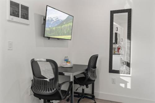 a room with a table and two chairs and a mirror at New Season Royals, Airport West in Chester