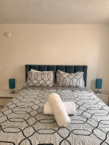 a bedroom with a bed with two towels on it at Your Cozy Place in West Palm Beach