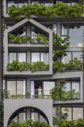 a building with lots of plants on the balconies at Leaf Beachfront Hotel Da Nang in Danang
