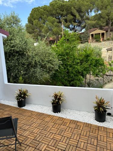 a patio with potted plants on a white fence at Pirella House in Limassol
