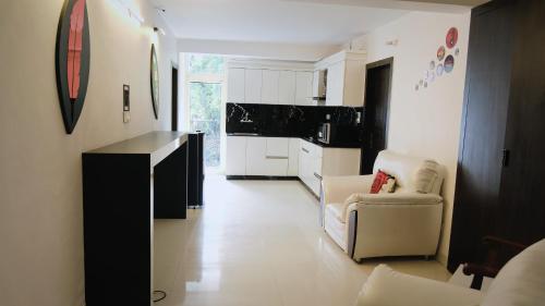 a kitchen with two chairs and a table in a room at The White House in Nainital