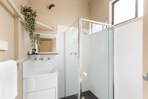 a bathroom with a shower and a sink at Robe Holiday Park in Robe