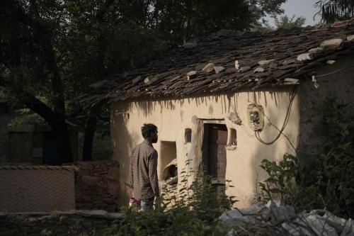 a man standing outside of a small house at TatSaraasa Resort & Spa, Udaipur in Udaipur
