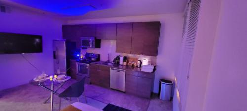 a kitchen with purple lights in a room at Exclusive Suites in MDR-Venice with Pool, GYM & HotTub in Los Angeles