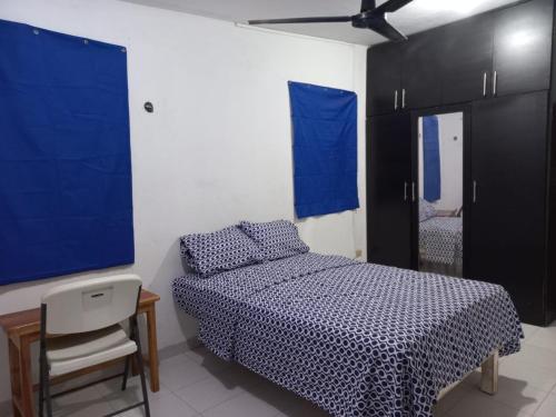 a bedroom with a bed and a desk and a tv at CASA ALTABRISA in Mérida