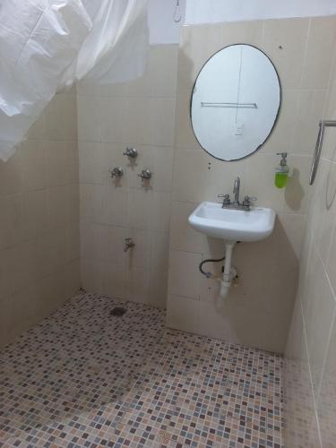 a bathroom with a sink and a mirror at CASA ALTABRISA in Mérida