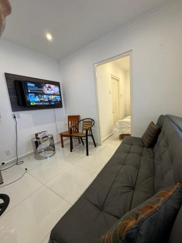 a living room with a couch and a flat screen tv at THE VIEW APPARTMENTS in Willemstad