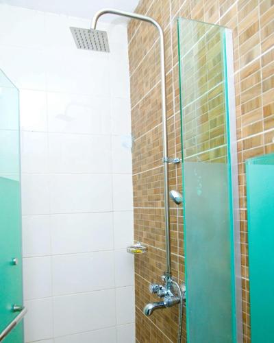 a shower with a glass door in a bathroom at D2 Studio Apartment in Lagos