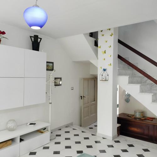 a room with white walls and a staircase with stars on the wall at Il giardino di Emilia in Raviscanina