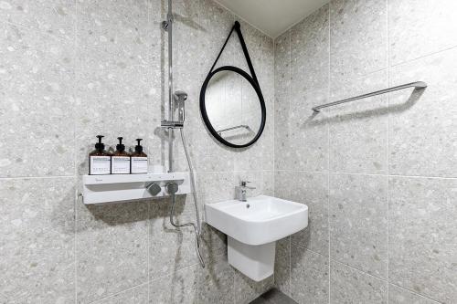 a bathroom with a sink and a mirror at Hotel Yaja Terminal Branch in Jeonju