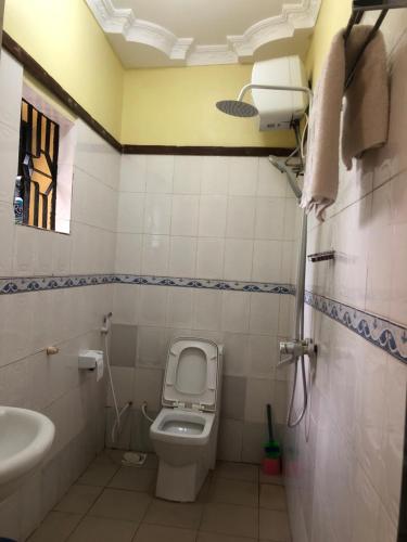 a small bathroom with a toilet and a sink at CBA Hotel in Tanga