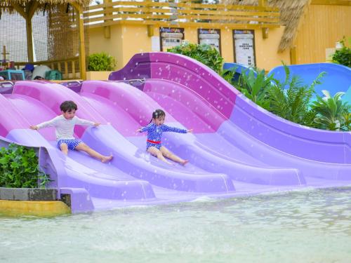 two children sliding down a water slide at a water park at Latterace Resort in Yeosu