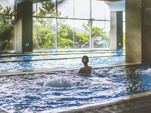 a woman swimming in a swimming pool at Latterace Resort in Yeosu