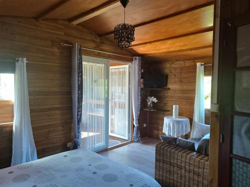 a bedroom with a bed and a sliding glass door at Le Clos des Mimosas in La Plaine des Palmistes