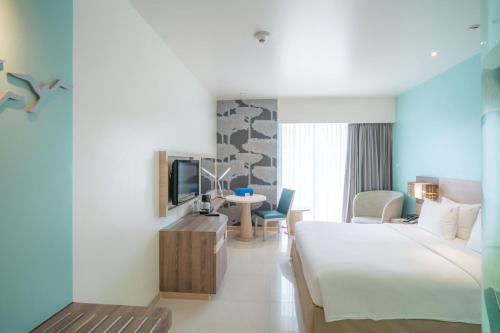 a hotel room with a bed and a desk at Holiday Inn Express Phuket Patong Beach Central by IHG in Patong Beach