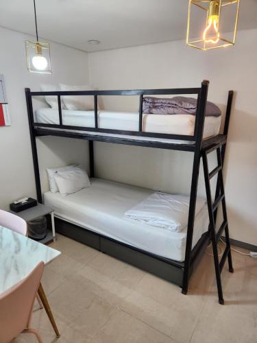 a room with two bunk beds and a table at Shinchon Y Hotel in Seoul