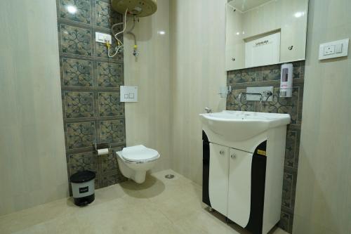 a bathroom with a sink and a toilet at Nature's Edge Nishat Srinagar in Srinagar