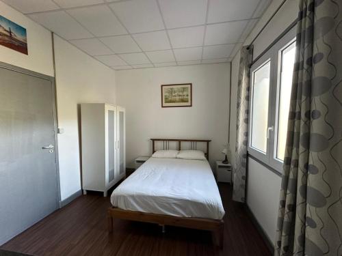 a small bedroom with a bed and a window at Domaine des Anges in Amélie-les-Bains-Palalda