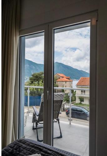 a bedroom with a sliding glass door to a balcony at Luxury apartment Vasilisa in Kotor