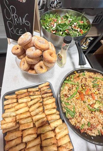 a table with plates of food and plates of food at Tequila Sunrise Hostel Sydney in Sydney