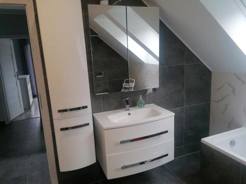 a bathroom with a sink and a mirror at Dom wakacyjny in Mściszewice