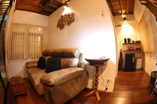 a living room with a couch and a chair at Baanrongmai Canal Front in Bang Chak