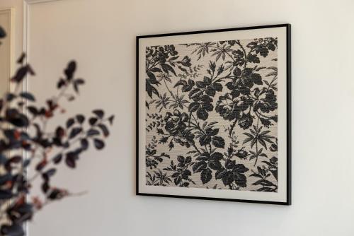 a framed picture of flowers on a wall at Shanghai Yi Du B&B -Family - Friendly Suite Close to People's Square and Subway in Shanghai