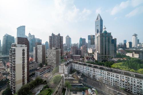 a view of a city skyline with tall buildings at Shanghai YD B&B - People's Square Xintiandi Store near Huangpi South Road subway in Shanghai