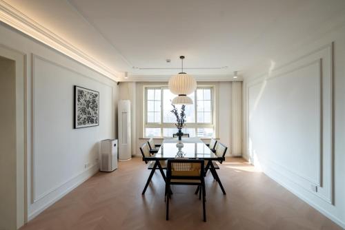 a dining room with a table and chairs at Shanghai Yi Du B&B -Family - Friendly Suite Close to People's Square and Subway in Shanghai