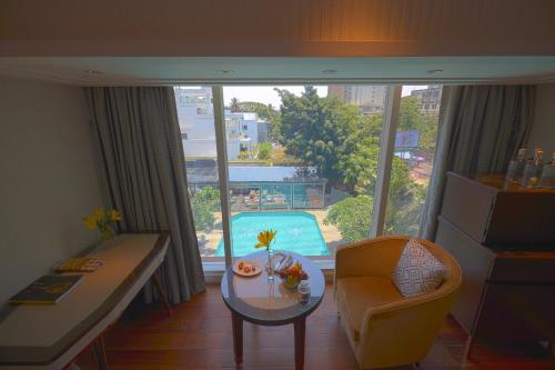 a living room with a table and a view of a pool at Taj MG Road Bengaluru in Bengaluru