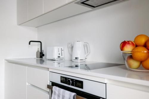 a kitchen with a bowl of fruit on a counter at Hestia Hotel Barons Old Town in Tallinn