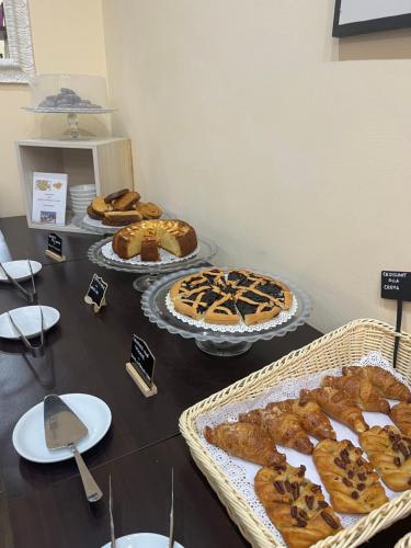 a table with several different types of cakes and pies at Hotel La Torraccia in Tarquinia
