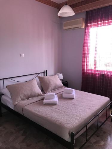- une chambre avec un lit et 2 serviettes dans l'établissement Sunrise View Apartment, à Chios