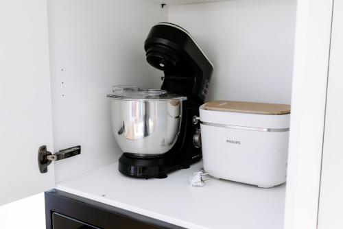 a mixer sitting on a counter next to a container at Hestia Hotel Barons Old Town in Tallinn