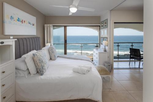 504 Bermudas - by Stay in Umhlanga في ديربان: غرفة نوم مع سرير وإطلالة على المحيط