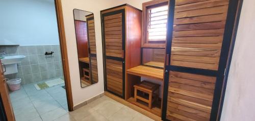 a bathroom with a shower with a toilet and a sink at Nosy Bay View in Nosy Be