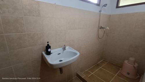 a bathroom with a sink and a shower at Bamboo Sanctuary Pancawati Resort Bogor in Ciherangsating