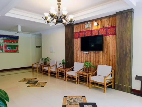 a conference room with a table and chairs and a television at Saigon-Ba Be Resort in Ba Be