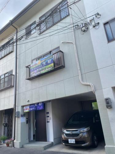 a car parked in front of a building at GUESTHOUSE UJIRIVER Kyoto RENTAL CAR Paid shuttle Rental bicycle in Uji